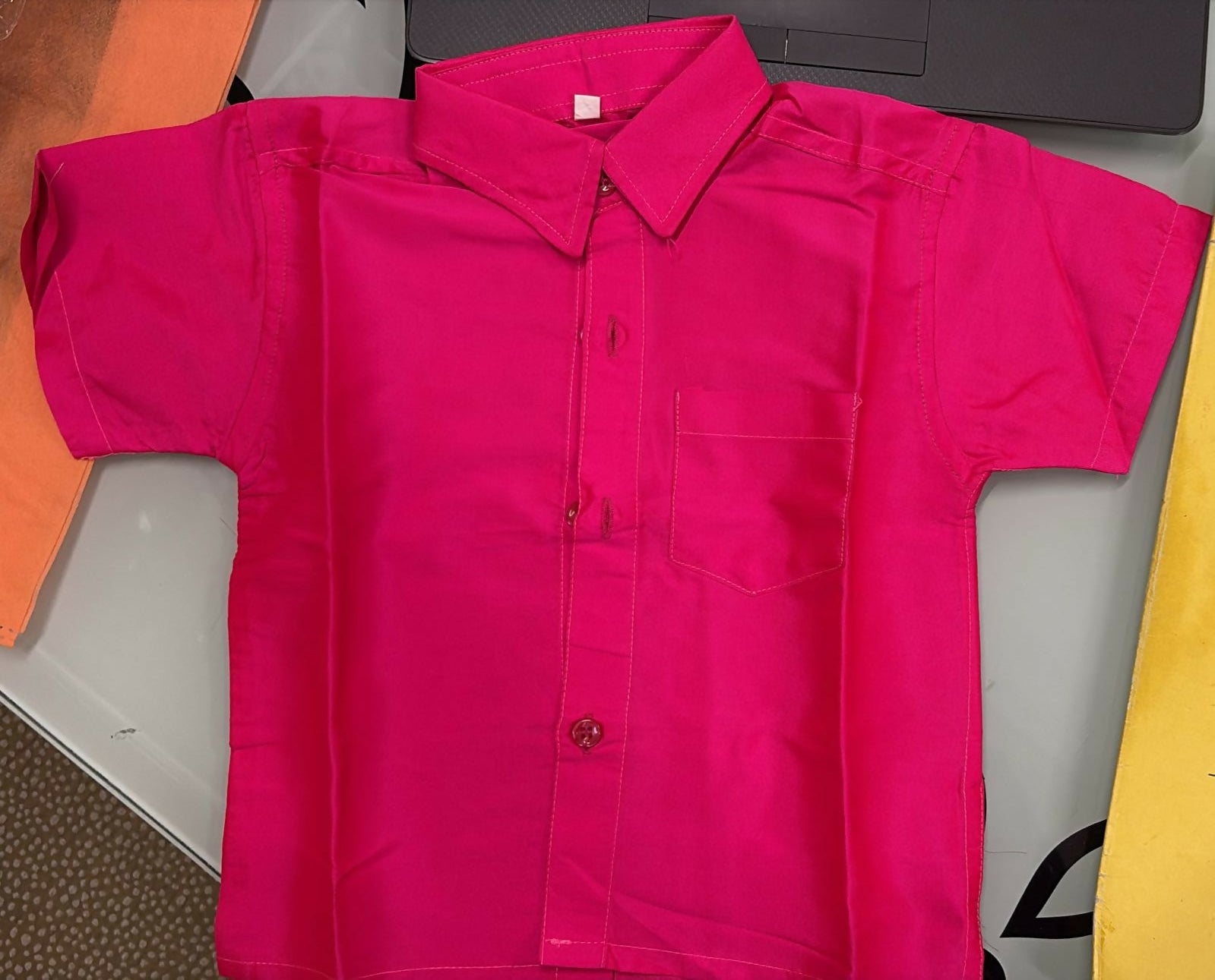 Pink jacket on a table with a colorful background