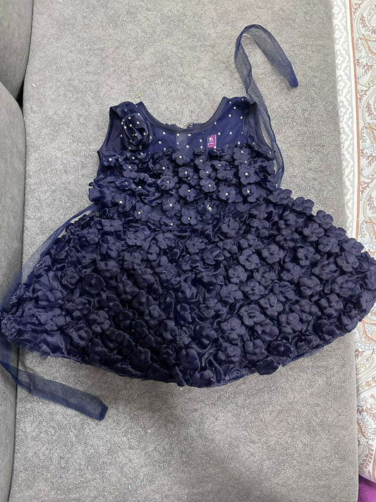 Navy blue floral dress with a matching headband on a gray surface