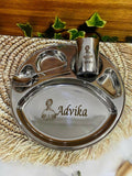 Personalized stainless steel kids thali set with 5 compartments, engraved name ‘Advika’, including spoon, fork, and glass with princess design.