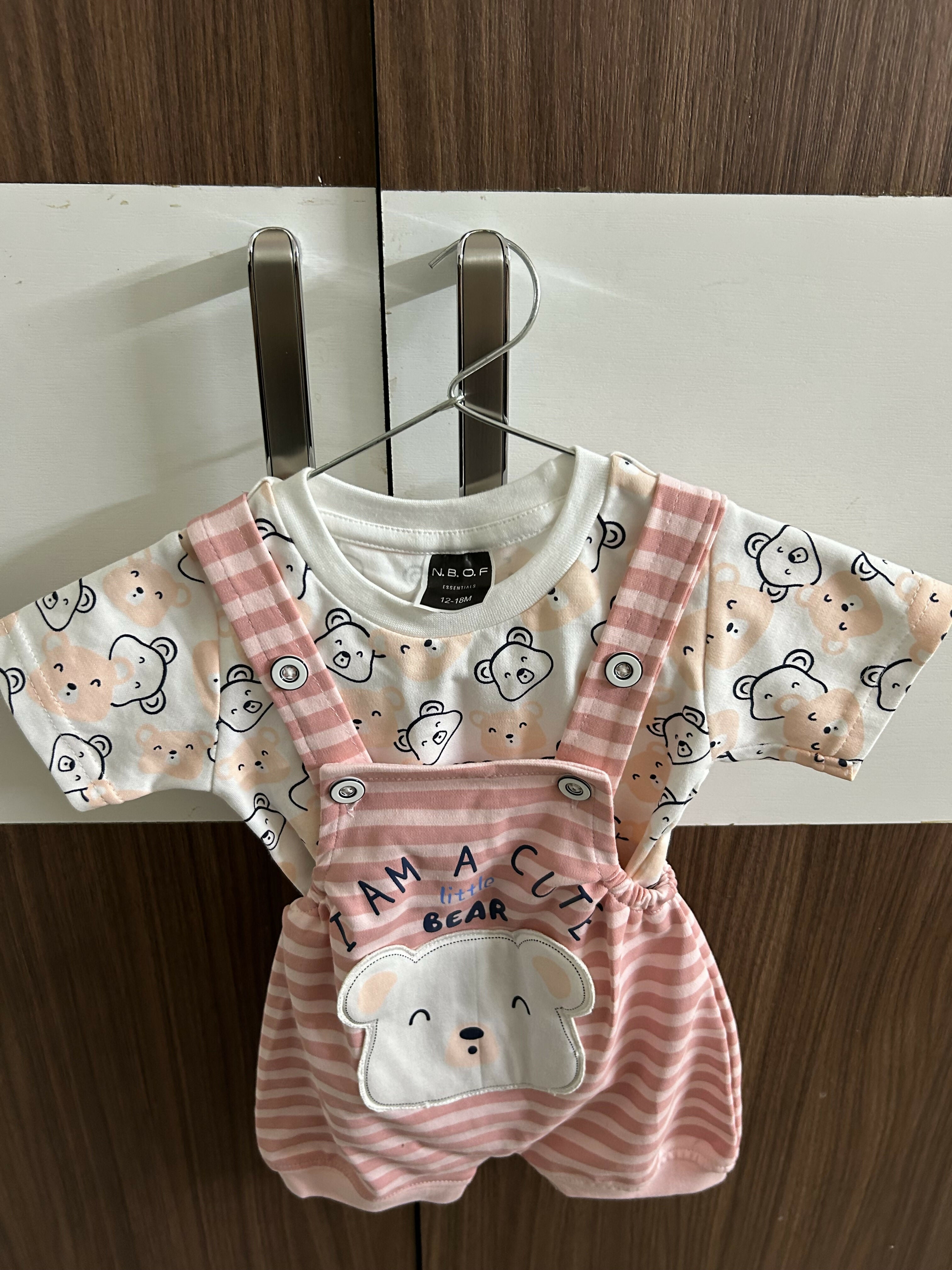 Children's outfit with pink bear-themed overalls and shirt