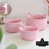 Three pink woven baskets