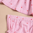 Red and white striped children's outfit with heart patterns 