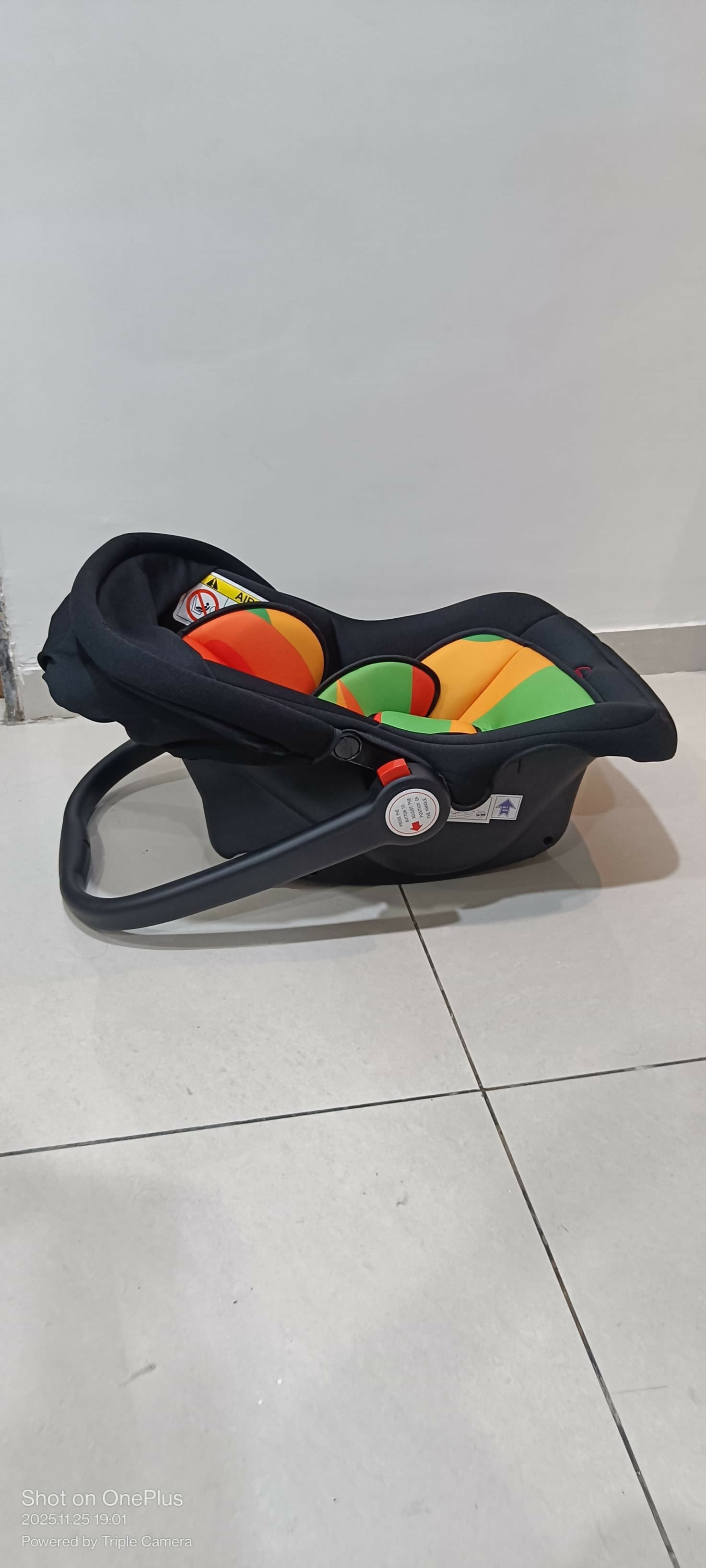 Black baby car seat with colorful design 