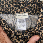 Leopard print fabric with a label on a neutral background