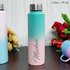 Gradient water bottle transitioning from blue to pink with 'Muskkan' branding, surrounded by flowers.