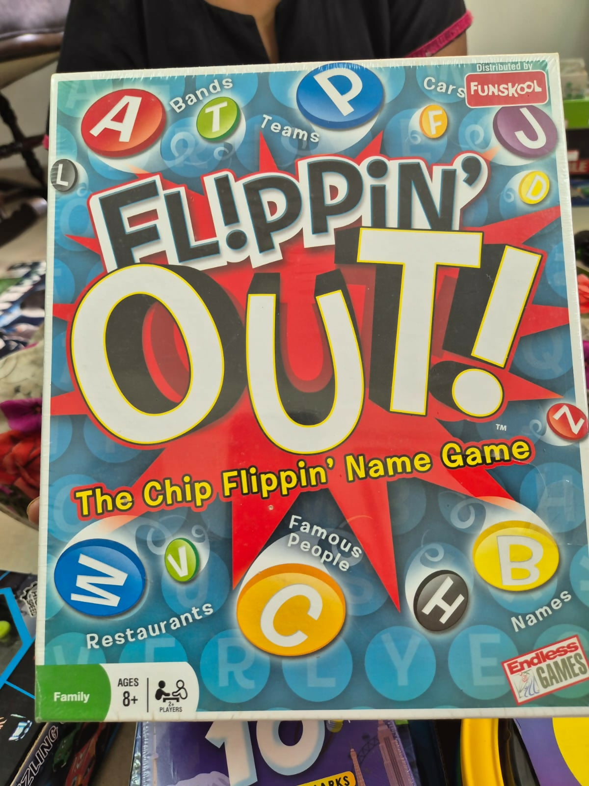 Board game box titled 'Flippin' Out!' with colorful letters 