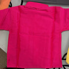 Bright pink shorts on a table with a colorful background