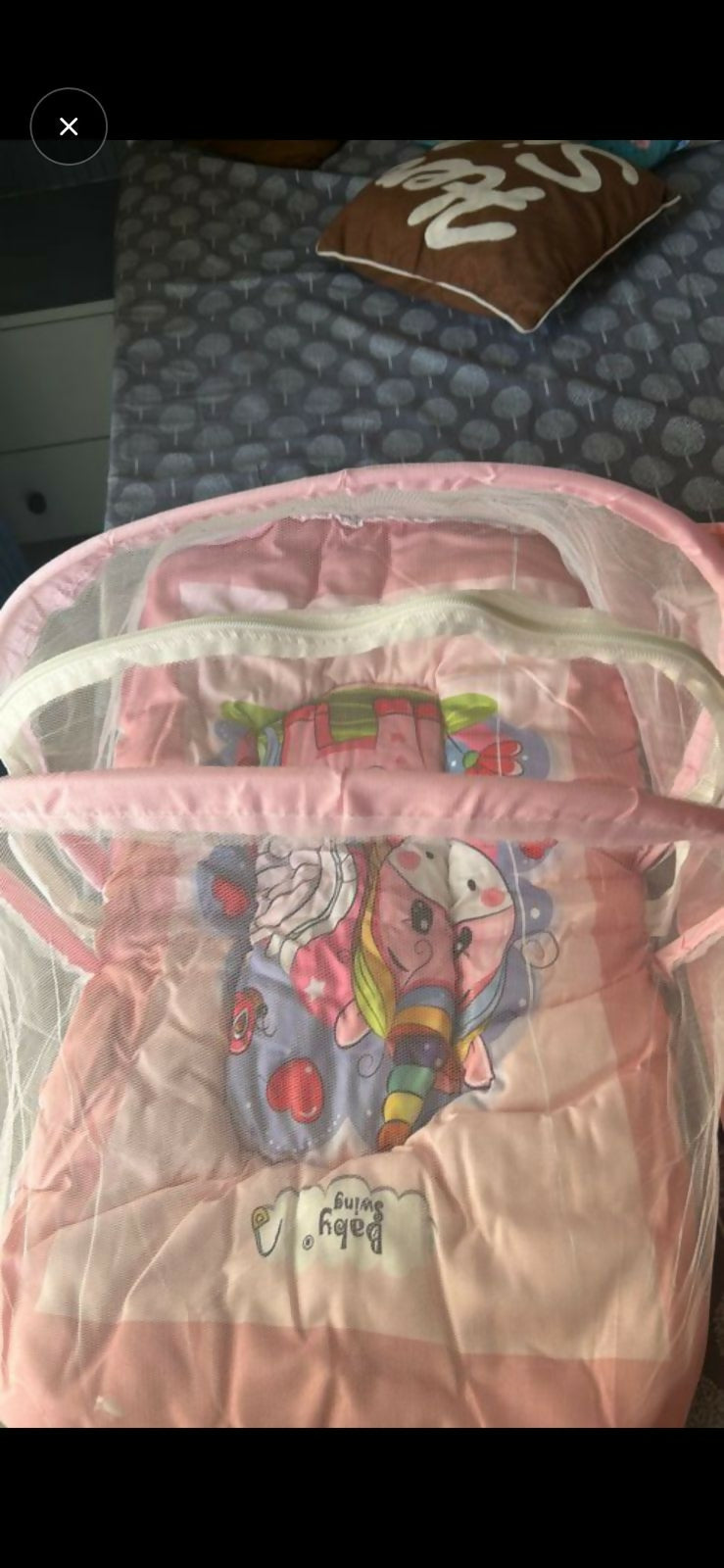 Pink baby crib with cartoon design 