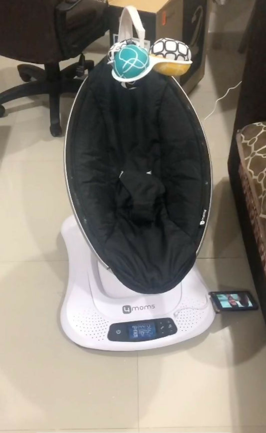 4MOMS MamaRoo Electric Baby Swing with comfortable seat and automatic motion.