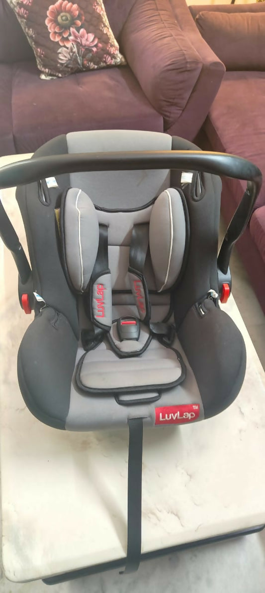 Child car seat on a white surface with a blurred background