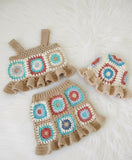 Crocheted baby outfit with colorful square patterns 