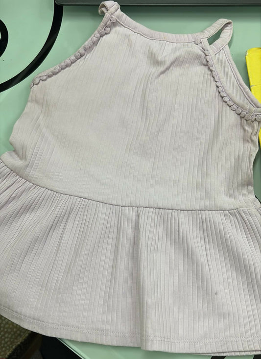 Light gray dress with ruffled straps on a green background
