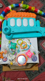 Colorful baby toy set with a bus-shaped rattle and plastic rings 