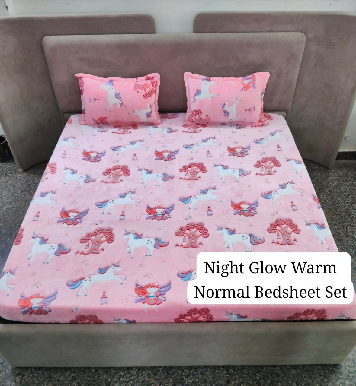 Pink unicorn-patterned bedsheet set on a bed with pillows.