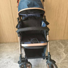 Blue and black stroller with rose gold accents 