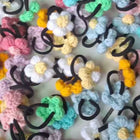 Colorful hair ties with floral designs on a white background