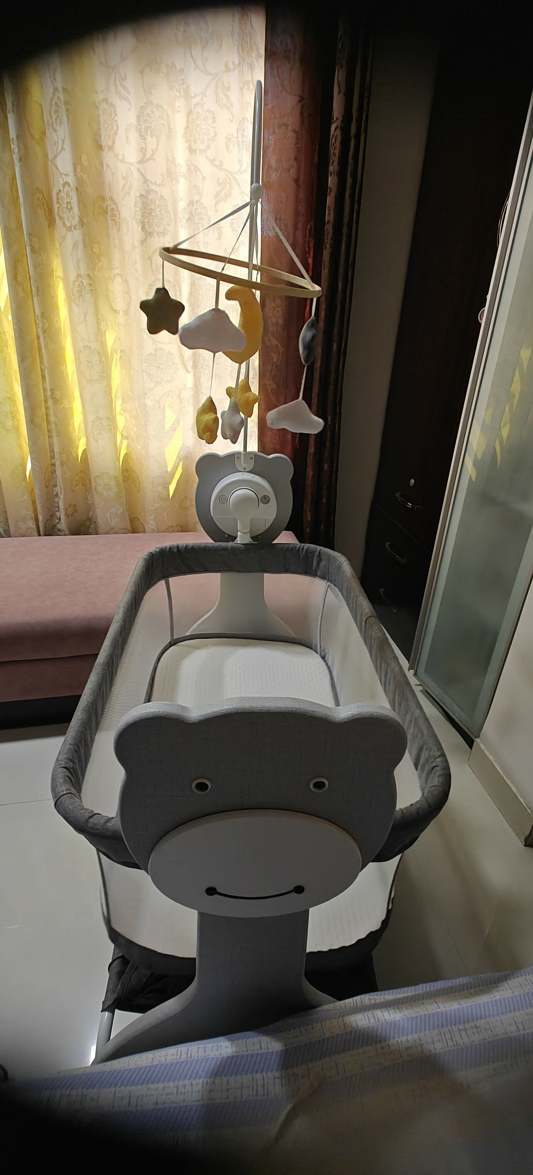 Baby crib with a mobile attached 