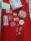 Breast pump parts and accessories on a red surface