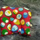 Colorful children's seat pad with animal patterns on a marble surface