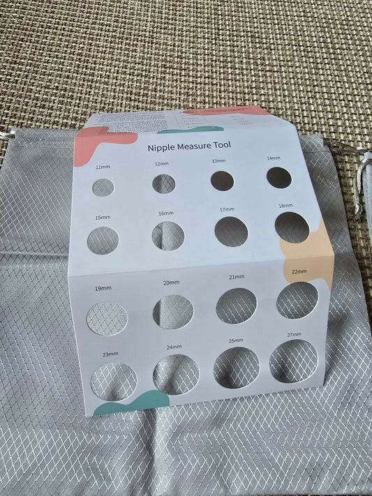 Nipple measure tool packaging on a textured fabric background