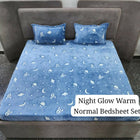 Blue night glow warm normal bedsheet set with star and moon pattern on a bed.