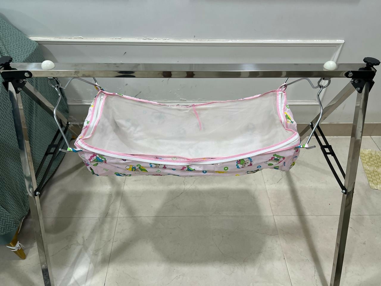 A TO Z HUB portable folding Ghodiyu traditional baby cradle with black cotton cloth, foldable metal frame, gentle rocking design, and a comfortable sleeping space for newborns and infants.