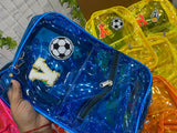 Blue transparent pouch with soccer ball design held by a hand, surrounded by other colorful pouches.