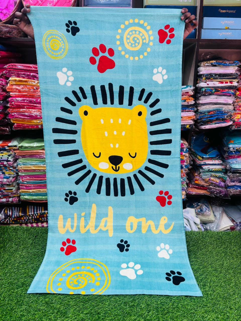Children's towel with a lion design and 'wild one' text 