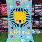 Children's towel with a lion design and 'wild one' text 