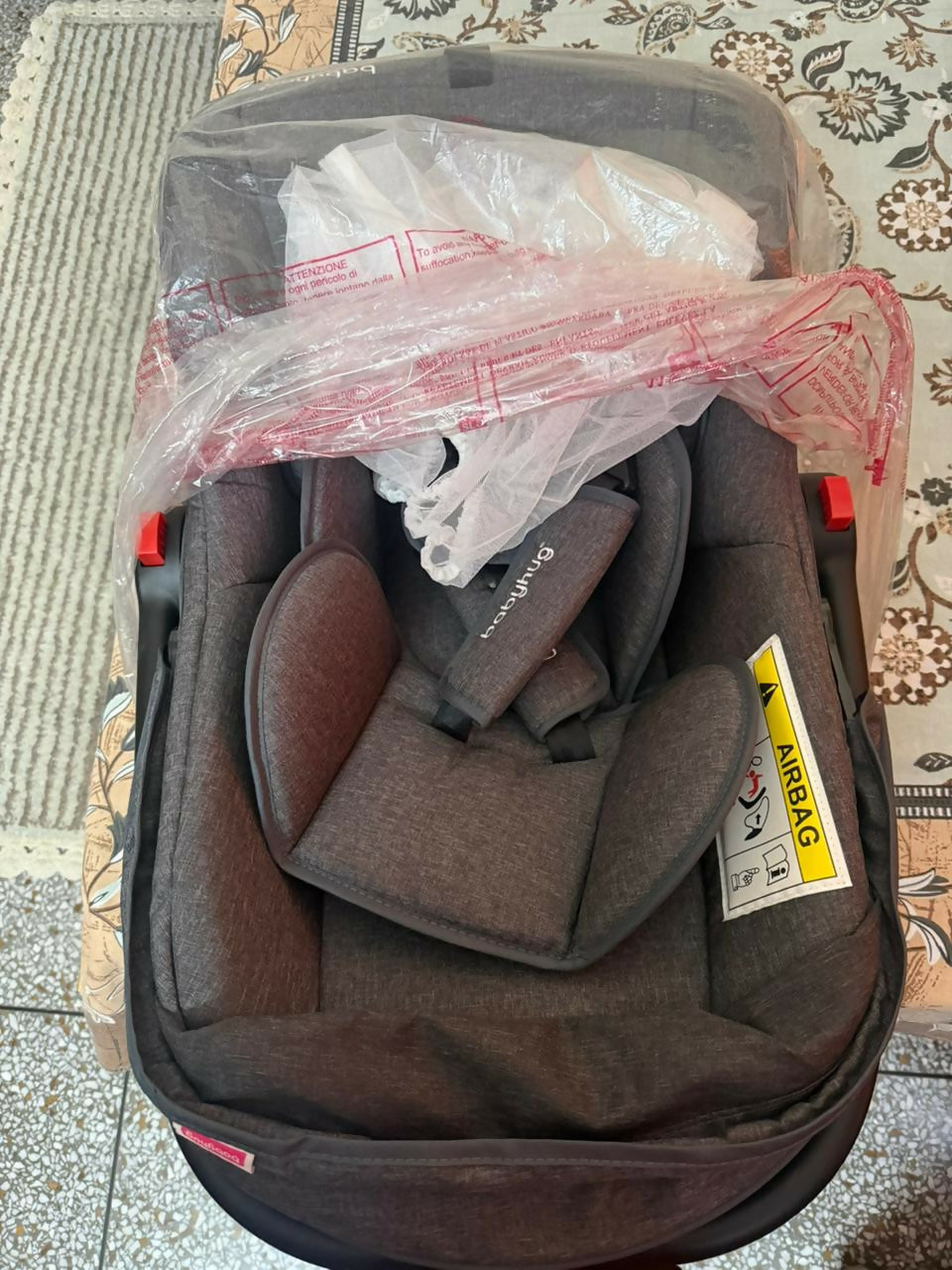 BABYHUG 4 in 1 car seat cum carry cot with multi-function design, safety harness, cushioned seating, portable carry handle, and comfortable travel support for babies.