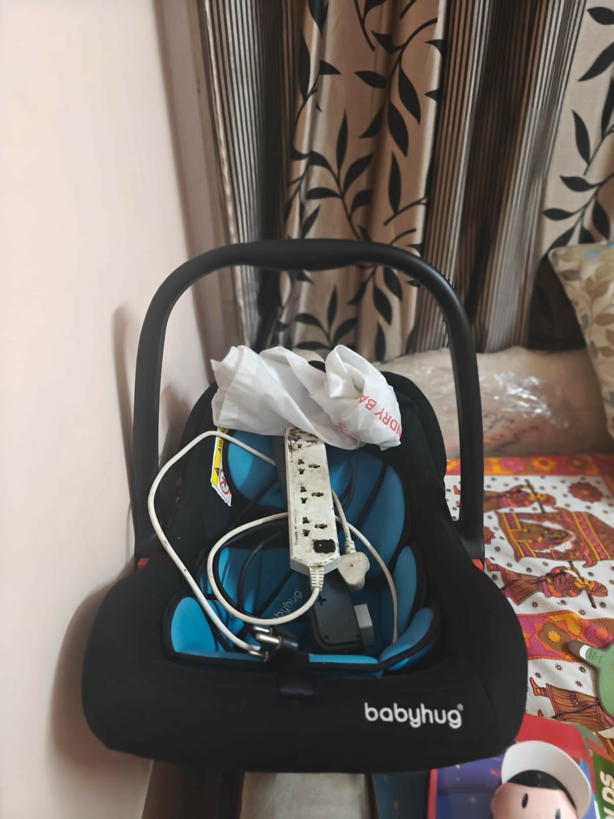 BABYHUG Amber Car Seat Cum Rocker in Almost New condition, featuring comfortable padded seating, safety harness, ergonomic carry handle, protective canopy, and versatile rocking function for convenient infant travel and supervised relaxation.
