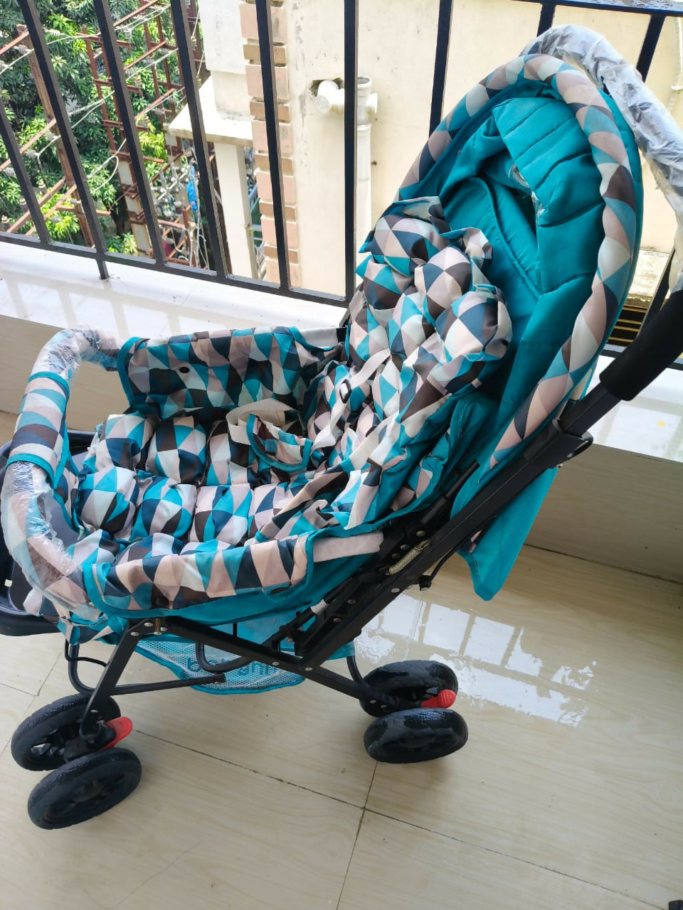 BABYHUG Cocoon Blue stroller with reclining seat, smooth wheels, safety harness, adjustable canopy, and comfortable travel design for babies and toddlers.