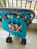 BABYHUG Cocoon Blue stroller with reclining seat, smooth wheels, safety harness, adjustable canopy, and comfortable travel design for babies and toddlers.