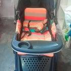 Babyhug Melody stroller with a reversible handle, adjustable canopy, reclining seat, 5-point safety harness, smooth wheels, and a lightweight foldable design for comfortable everyday travel.