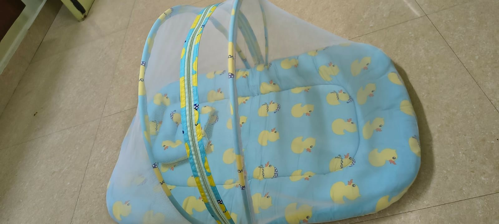 BABYHUG cotton bedding set with mosquito net featuring a soft mattress, pillow, breathable cotton fabric, and protective mosquito net for a comfortable and secure sleeping environment for babies.