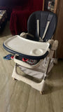 STAR AND DAISY Galaxy Star High Chair with comfortable padded seat, adjustable feeding tray, safety harness, sturdy frame, footrest, and easy-clean design for convenient baby and toddler mealtimes.