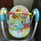 Mastela Deluxe Portable Swing Aqua with a comfortable cushioned seat, soothing swing motion, secure safety harness, compact foldable design, and calming features for babies.