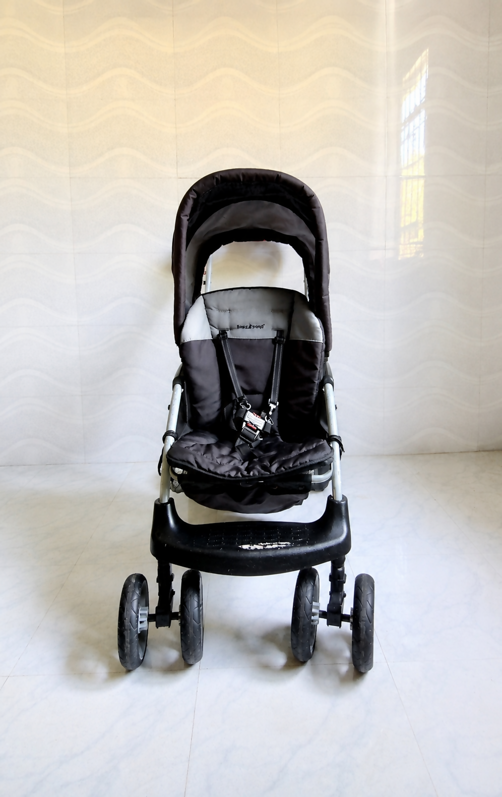 Baby Trend Sit N Stand LX double stroller tandem travel pram with front and rear seating, standing platform, safety harness, canopy, and smooth wheels for siblings.