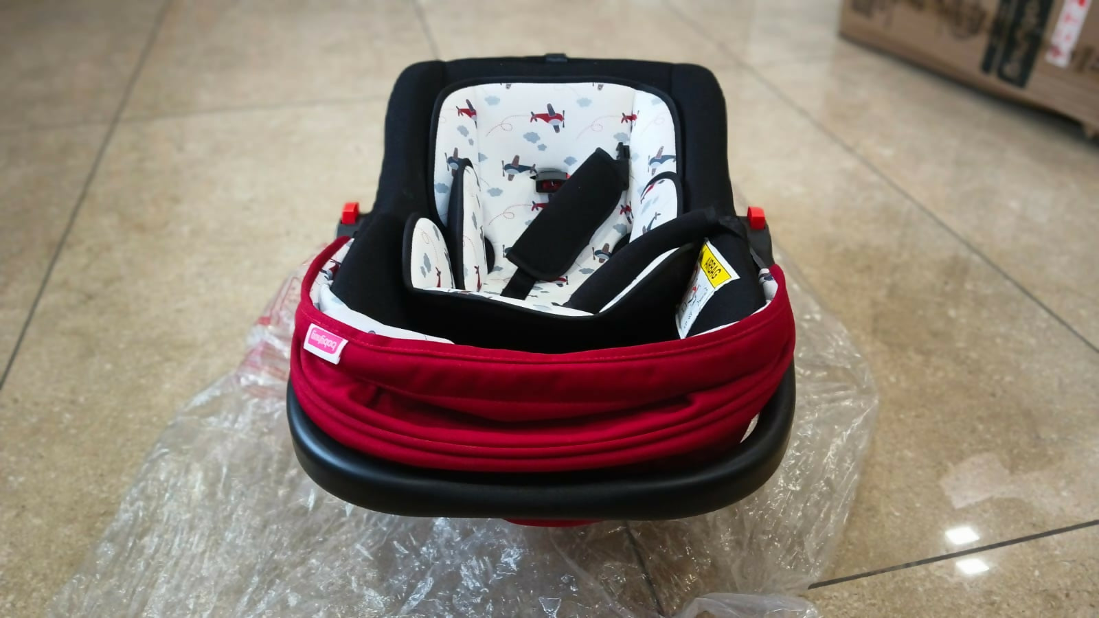 Babyhug Amber Car Seat Cum Carry Cot with padded seating, secure safety harness, ergonomic carry handle, protective canopy, and versatile design for comfortable travel with newborns and infants.