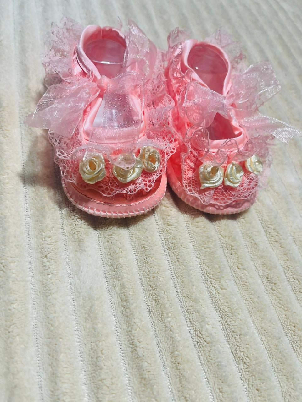 Handcrafted baby booties made from soft, baby-friendly fabric or yarn with a cozy, lightweight design to keep little feet warm, comfortable, and stylish.