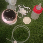 LUVLAP Adore electric breast pump with LUVLAP feeding bottle, adjustable suction settings, compact design, and convenient milk collection support for breastfeeding mothers.