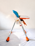 Chicco Polly foldable baby high chair with reclining feeding seat, adjustable tray, cushioned seating, sturdy frame, and premium design for comfortable baby mealtime and feeding.