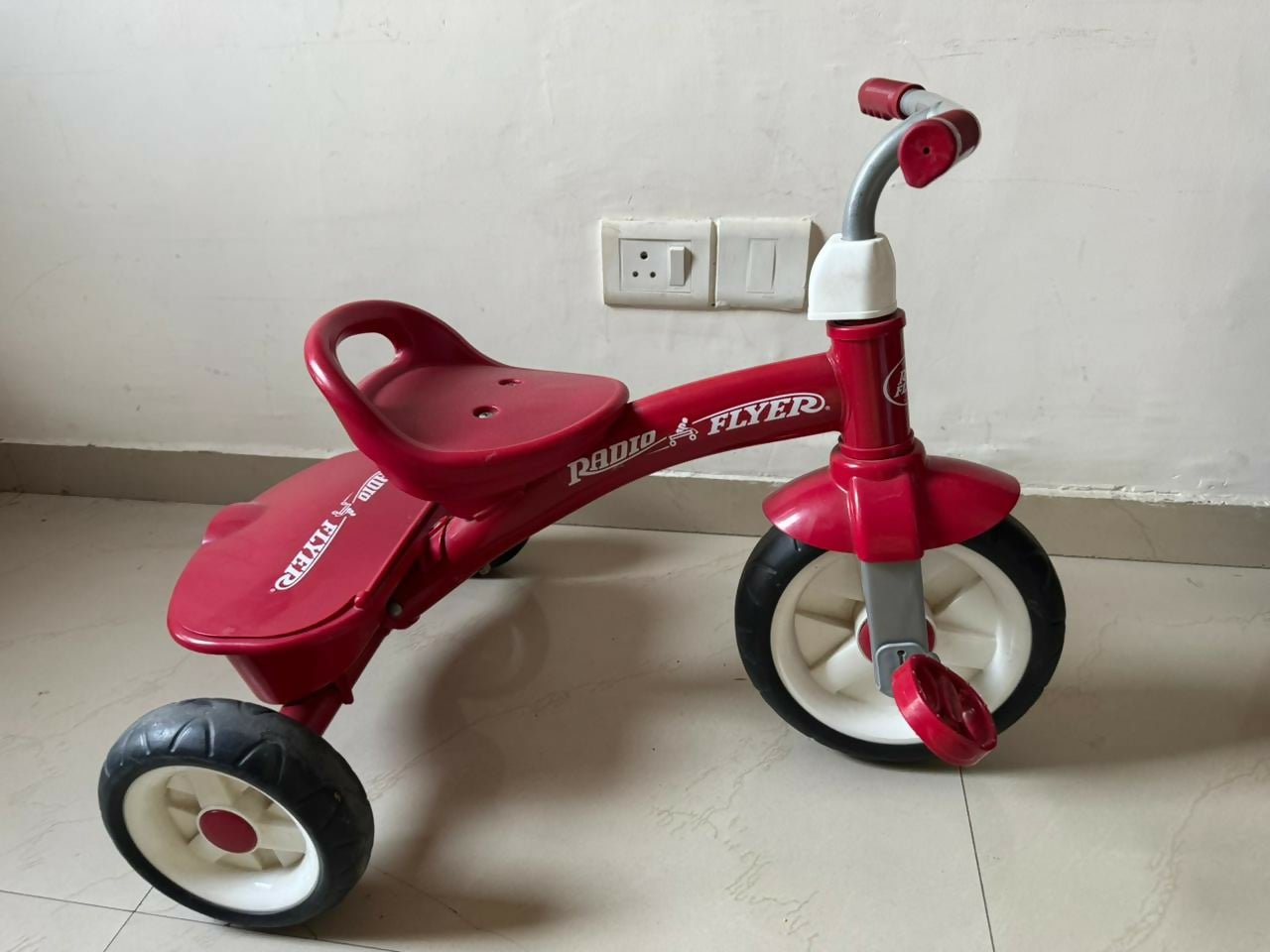 RADIO FLYER tricycle with sturdy construction, comfortable seat, easy-grip handlebars, smooth wheels, and child-friendly design for outdoor play and riding adventures.