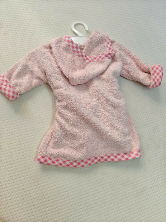 Pink children's robe with checkered trim on a hanger against a light background