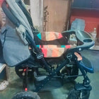 Babyhug Melody stroller with a reversible handle, adjustable canopy, reclining seat, 5-point safety harness, smooth wheels, and a lightweight foldable design for comfortable everyday travel.