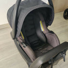 Evenflo travel system with baby stroller and infant car seat, featuring a foldable design, reclining seat, adjustable canopy, 5-point safety harness, and spacious storage basket for convenient travel.