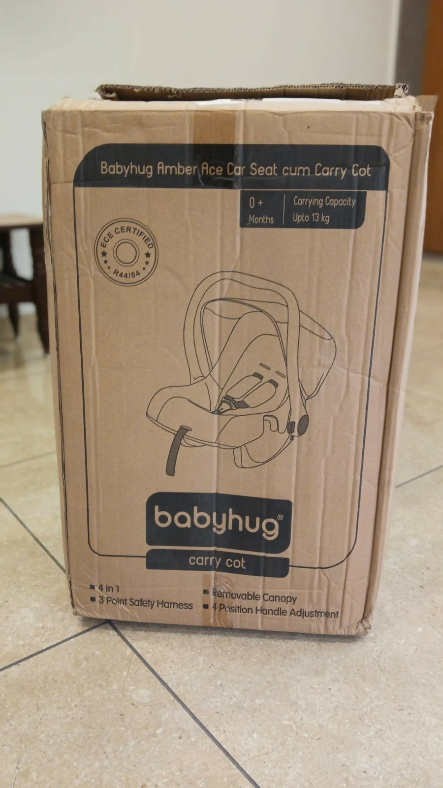 Babyhug Amber Car Seat Cum Carry Cot with padded seating, secure safety harness, ergonomic carry handle, protective canopy, and versatile design for comfortable travel with newborns and infants.