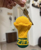 Handcrafted crochet FIFA World Cup-inspired keychain made from soft yarn, featuring a miniature football-themed design with durable key ring attachment, perfect for football fans, gifting, and everyday use.