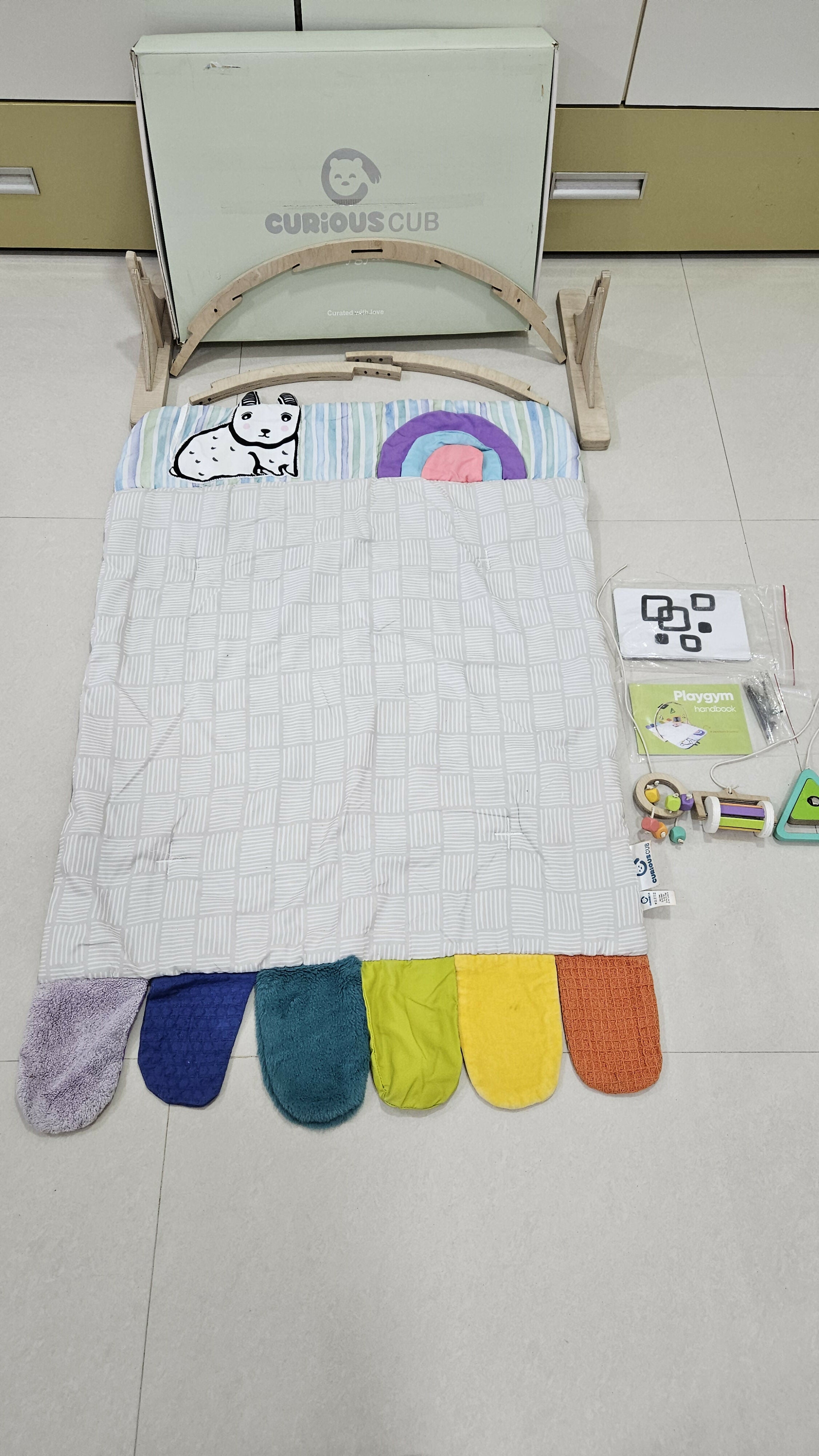 Curious Cub playgym with soft play mat, hanging sensory toys, interactive activity features, and engaging design to support baby development, tummy time, and play.