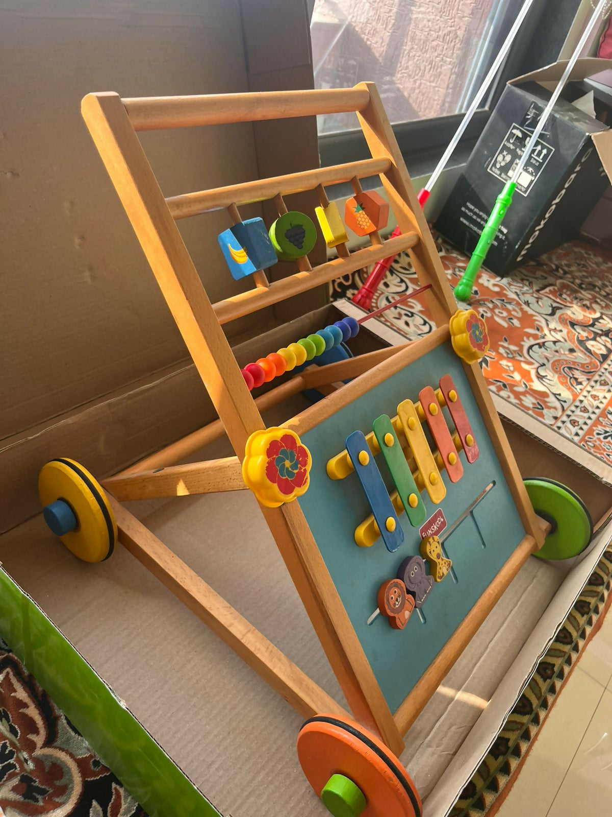 Children's wooden activity center with colorful toys 